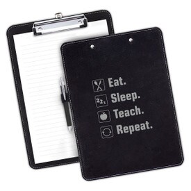 9"w x 12.5"h Richly Textured Clipboard Featuring The Inspirational Message: Eat Sleep Teach Repeat. Available In 5 Colors.