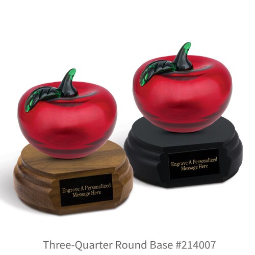 black and a brown walnut three-quarter round bases with black brass plates and red hanblown glass apples