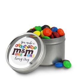 round tin with make a difference message and M&Ms